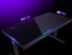 Dual-motor sit/stand adjustable-height gaming desk with built-in PC case, wireless charger, RGB lighting, control panel, and USB ports, tempered glass tabletop, black. 3